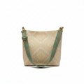 Beige tote bag with green strap on a windowsill